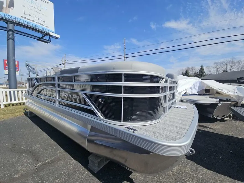 Slide: The Image of 2025 Bennington 188 SL pontoon boat displayed outdoors on a sunny day. - 3