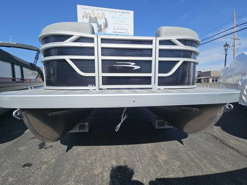 Slide: The Image of 2025 Bennington 188 SL pontoon boat front view on display outdoors. - 4