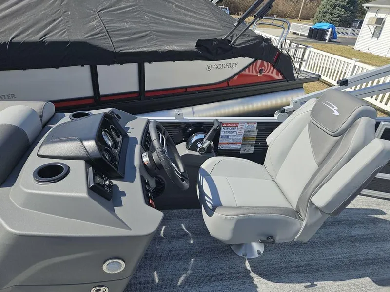 Slide: The Image of 2025 Bennington 188 SL boat interior with steering console and captain's chair. - 7