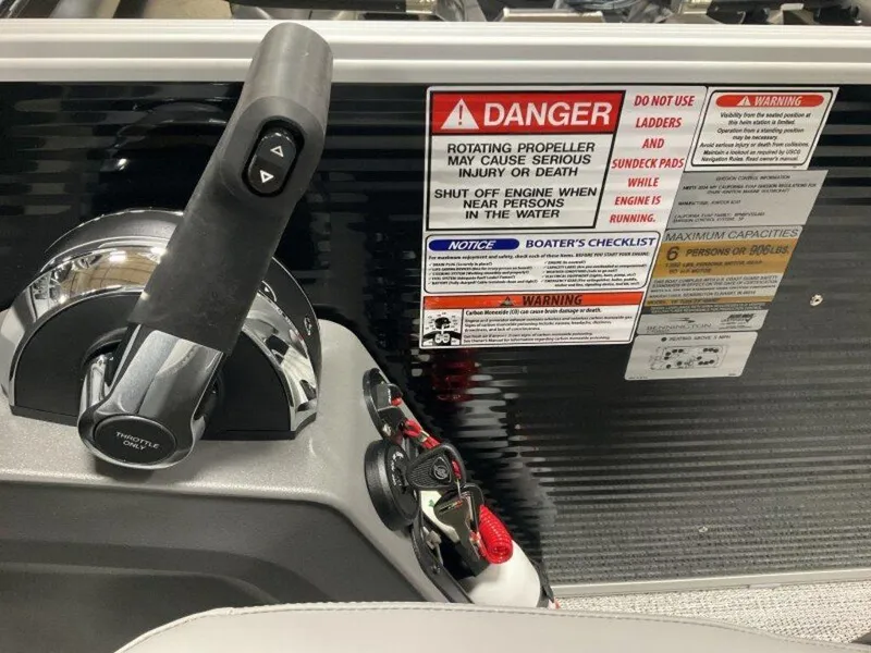 Slide: The Image of Control panel of 2025 Bennington 188 SL boat with safety warnings and throttle lever. - 9