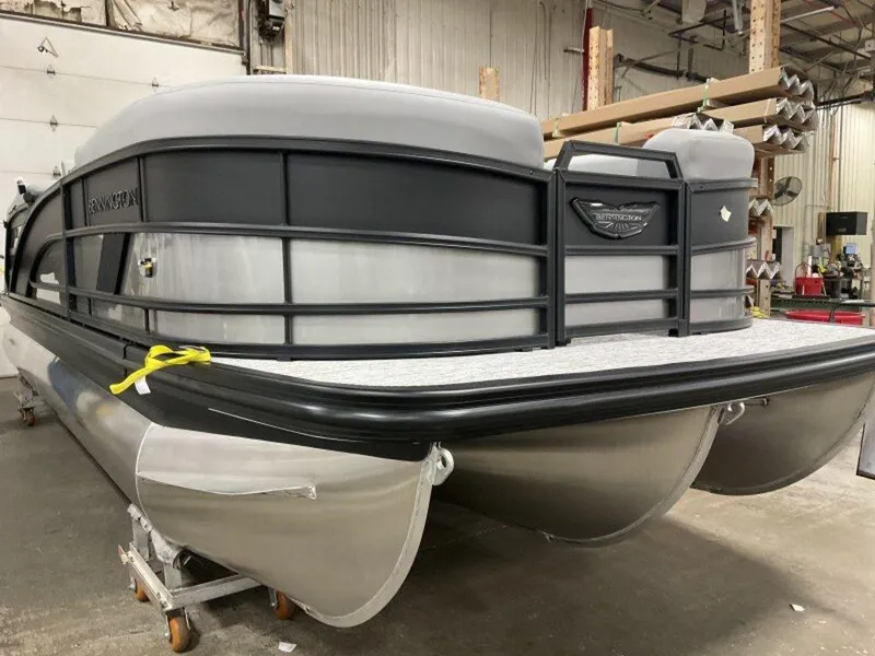 Slide: The Image of 2025 Bennington M Quad Bench 22 MFB pontoon boat in a warehouse setting. - 13