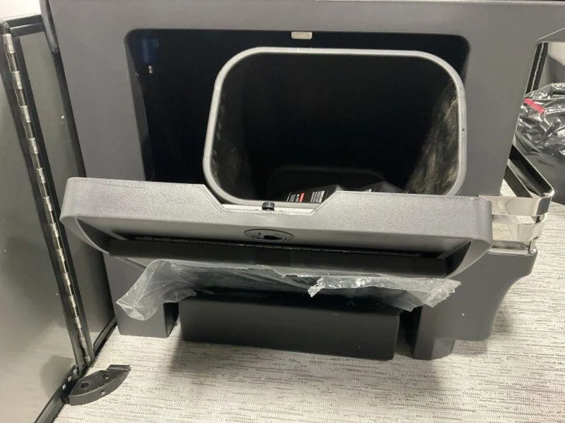 Slide: The Image of Open storage compartment of 2025 Bennington M Quad Bench 22 MFB boat. - 18