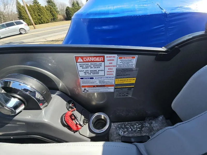 Slide: The Image of Interior view of a 2025 Bennington M Quad Bench 22 MFB with safety warning labels. - 21