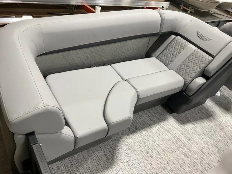 Slide: The Image of Luxurious seating on 2025 Bennington M Quad Bench 22 MFB boat, featuring elegant gray upholstery. - 4