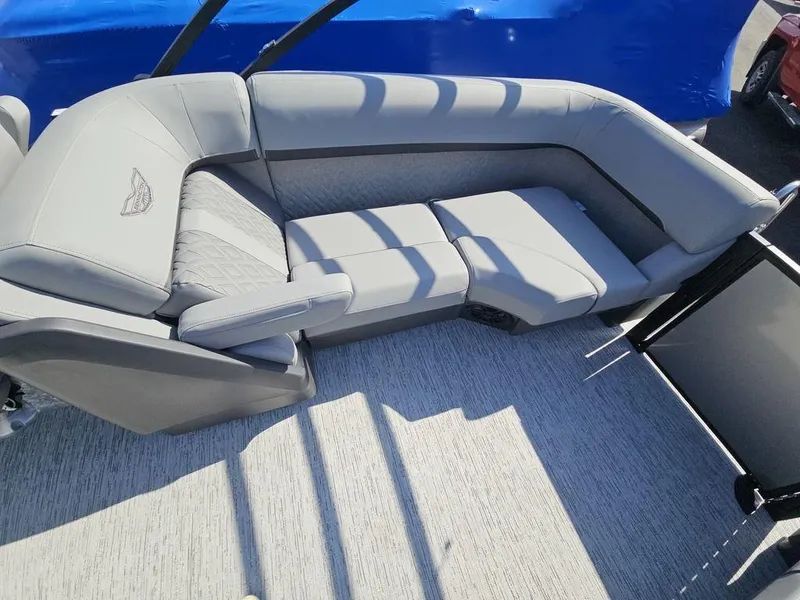 Slide: The Image of 2025 Bennington M Quad Bench 22 MFB with luxurious gray seating on a boat deck. - 7
