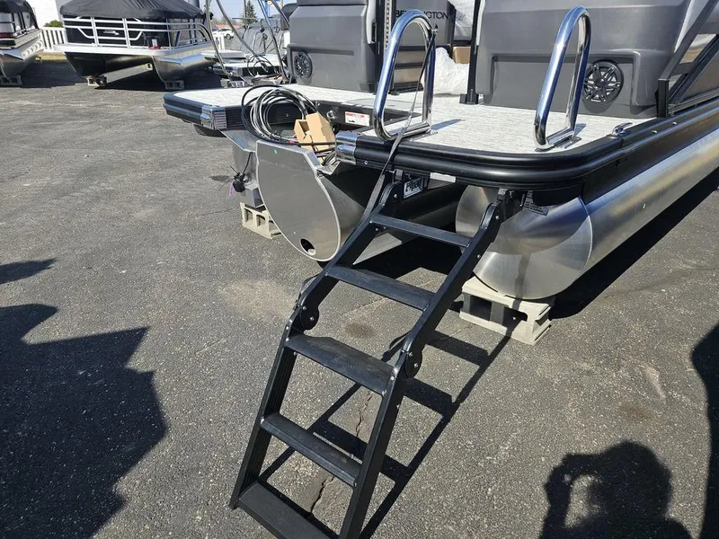 Slide: The Image of 2025 Bennington M Quad Bench 22 MFB pontoon boat with rear ladder and deck. - 9