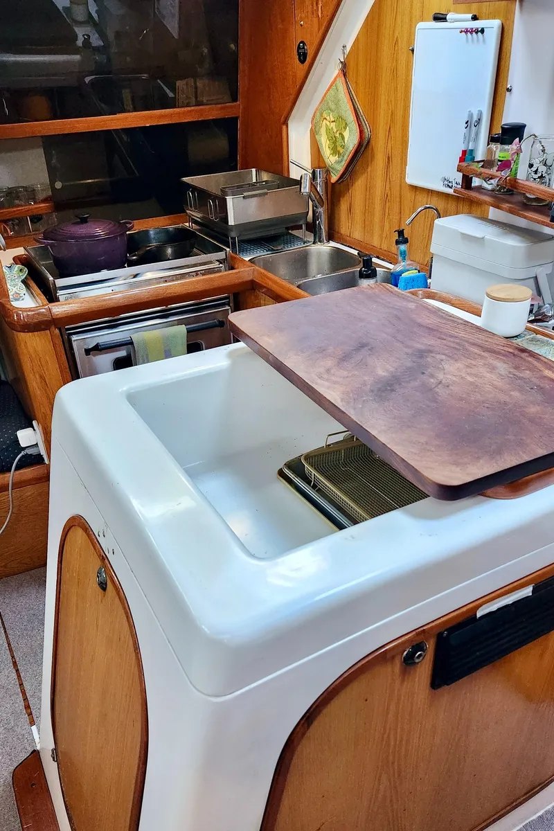 Slide: The Image of Interior of a 1985 Farr 50 yacht kitchen with wooden cabinetry and modern appliances. - 20