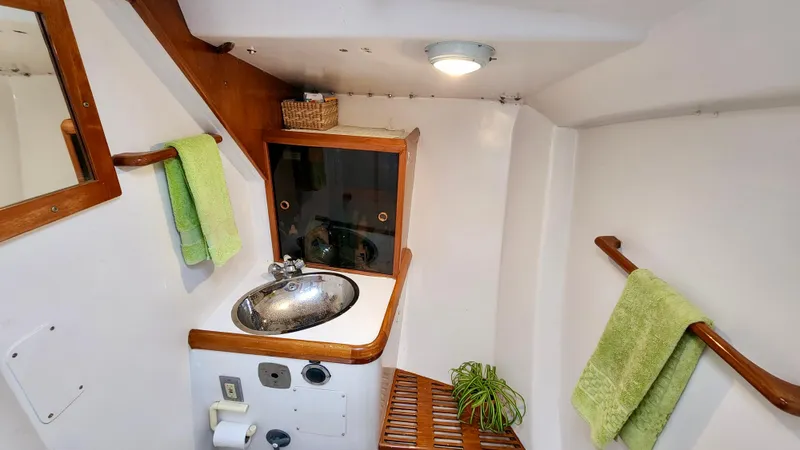 Slide: The Image of Compact bathroom in 1985 Farr 50 yacht with sink, mirror, and green towels. - 22