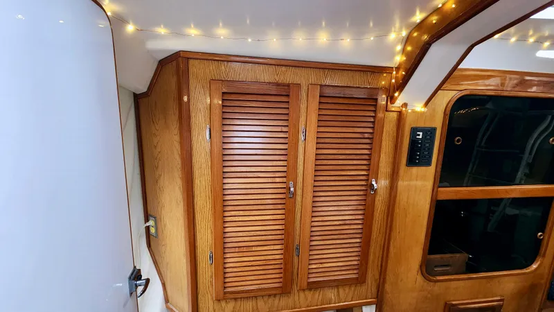 Slide: The Image of Interior of 1985 Farr 50 yacht with wooden cabinets and ambient lighting. - 25