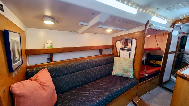 Slide: The Image of Interior of 1985 Farr 50 yacht with cozy seating and wooden accents. - 26