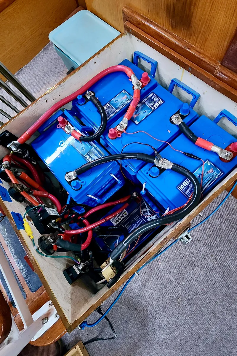 Slide: The Image of Battery compartment with blue batteries and red cables in a 1985 Farr 50 yacht. - 33