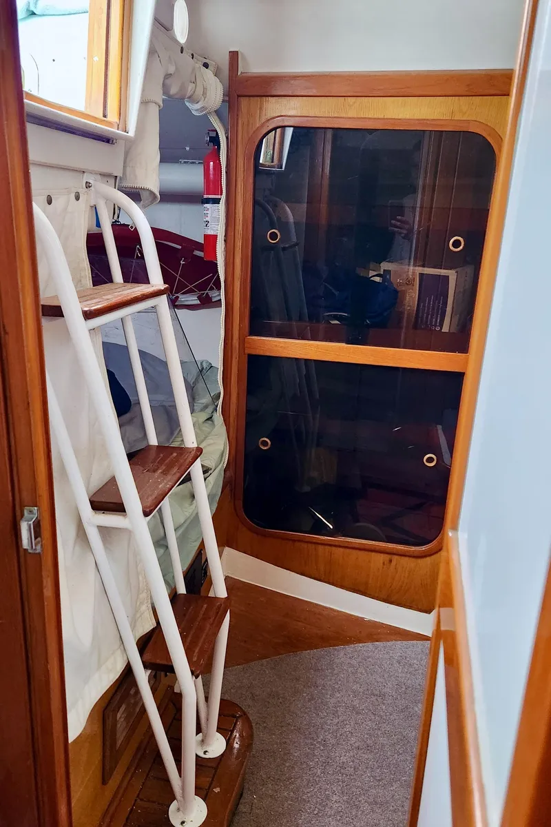 Slide: The Image of Interior of 1985 Farr 50 yacht with wooden accents and ladder. - 36