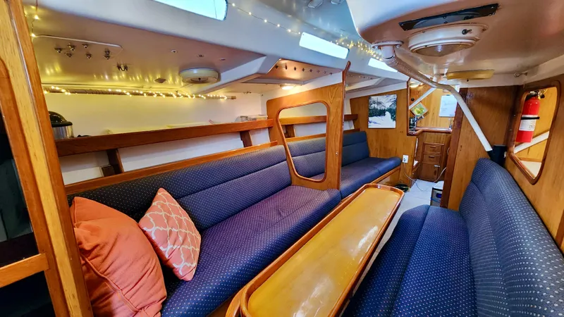 Slide: The Image of Interior of 1985 Farr 50 yacht with cozy seating and wooden accents. - 39