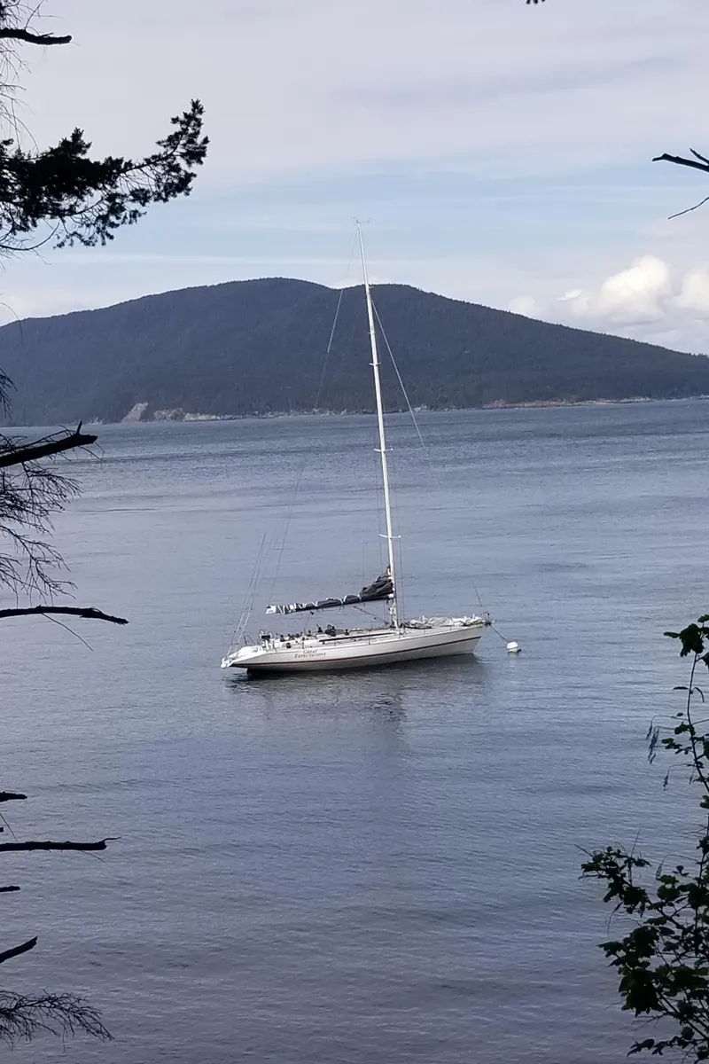 Slide: The Image of Sailboat on calm water with mountainous backdrop, Farr 50 model, 1985. - 42