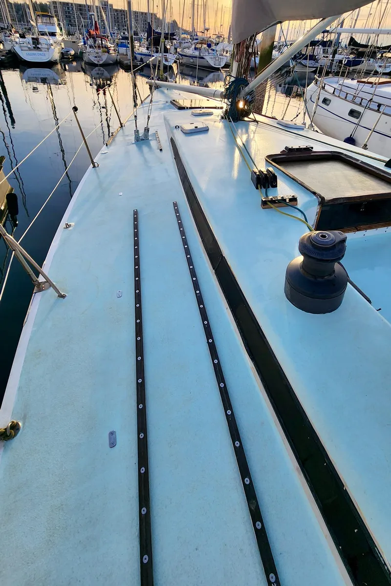 Slide: The Image of Deck view of a 1985 Farr 50 sailboat docked at a marina. - 8