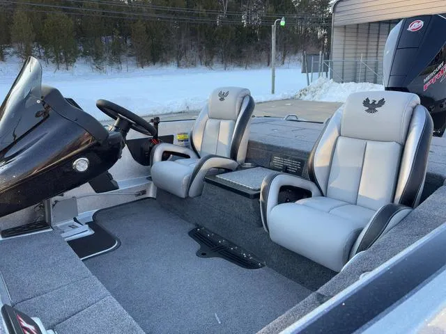 Slide: The Image of 2025 Phoenix 818 Pro boat interior with dual gray seats and steering console. - 13