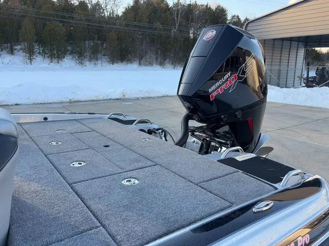 Slide: The Image of 2025 Phoenix 818 Pro boat with Mercury Pro XS engine, parked on snowy driveway. - 14