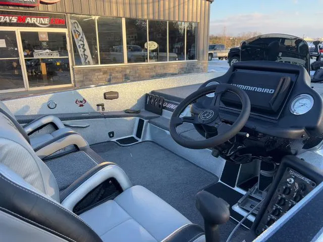 Slide: The Image of 2025 Phoenix 818 Pro boat interior with steering wheel and seats, displayed at a marine dealership. - 6