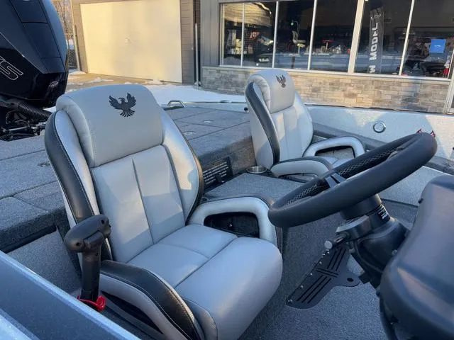 Slide: The Image of 2025 Phoenix 818 Pro boat interior with gray leather seats and steering wheel. - 7