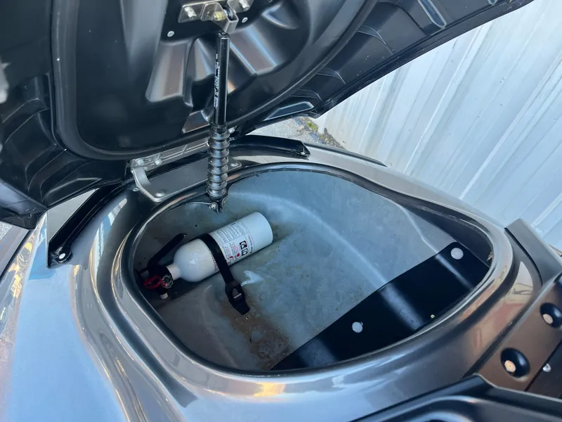 Slide: The Image of Open storage compartment of 2018 Yamaha WaveRunner FX Cruiser SVHO with fire extinguisher inside. - 10