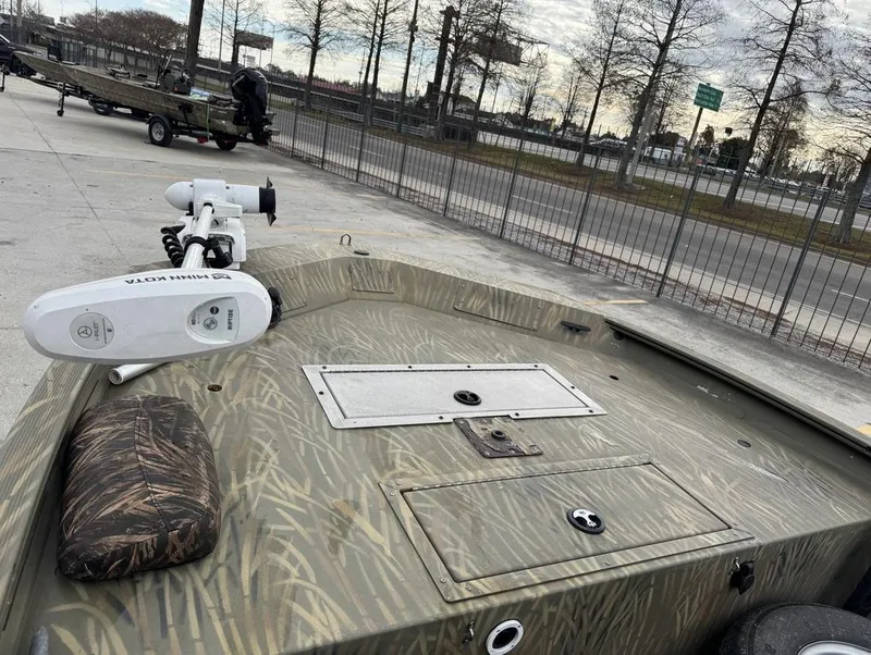 Slide: The Image of 2020 Tracker Grizzly 1860 CC boat with camo pattern and Minn Kota trolling motor. - 11