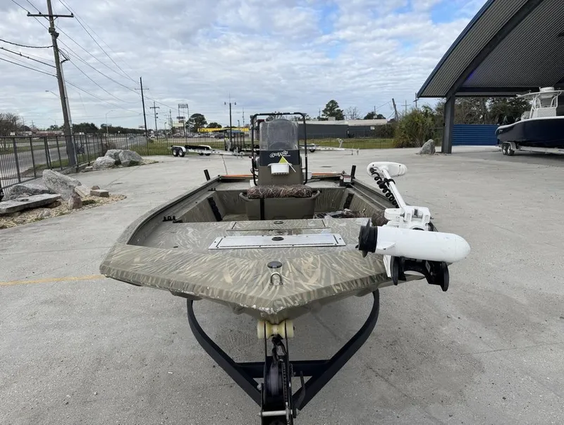 Slide: The Image of 2020 Tracker Grizzly 1860 CC boat on trailer, outdoor setting, overcast sky. - 4
