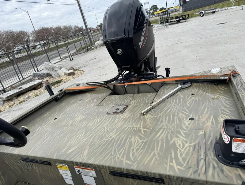 Slide: The Image of 2020 Tracker Grizzly 1860 CC boat with camo pattern and Mercury outboard motor. - 9
