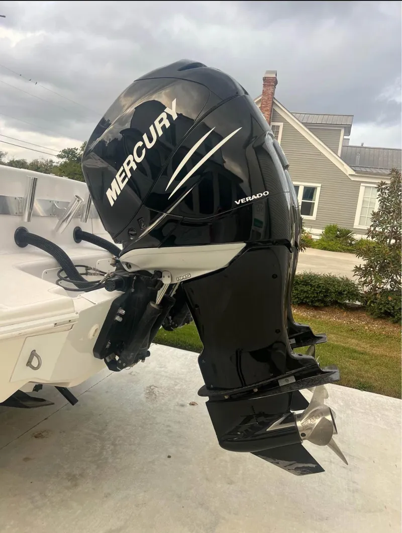 Slide: The Image of 2001 Donzi 32 ZF Open with Mercury Verado outboard engine, parked near a house. - 10