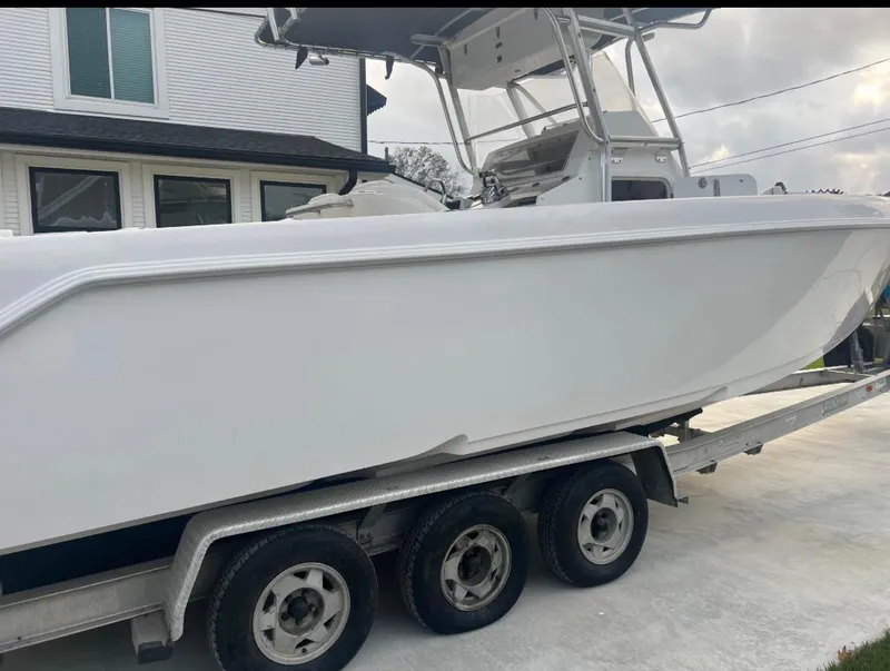 Slide: The Image of 2001 Donzi 32 ZF Open boat on a trailer, parked outside a house. - 17