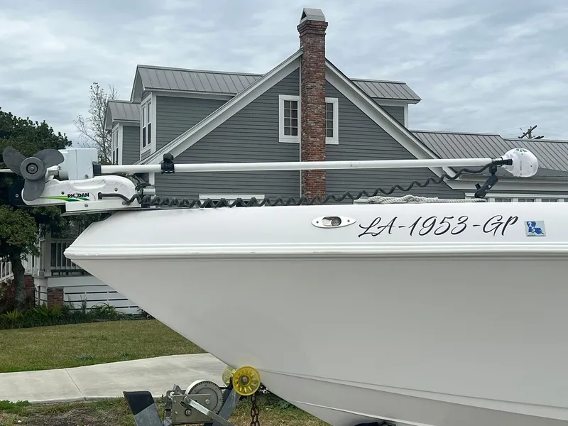 Slide: The Image of 2001 Donzi 32 ZF Open boat parked in front of a gray house with a chimney. - 19