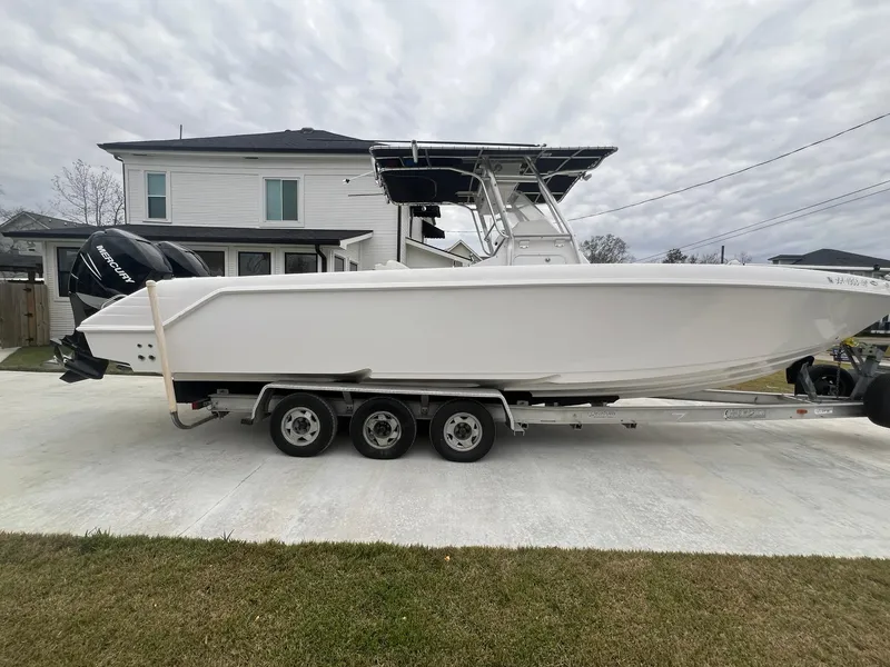 Slide: The Image of 2001 Donzi 32 ZF Open boat on trailer, parked in driveway. - 2