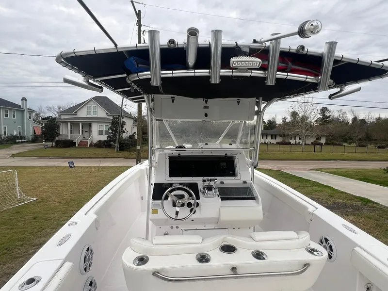 Slide: The Image of 2001 Donzi 32 ZF Open boat with T-top and console, parked in residential area. - 24