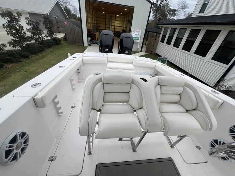 Slide: The Image of 2001 Donzi 32 ZF Open boat interior with white seating and dual outboard motors. - 27