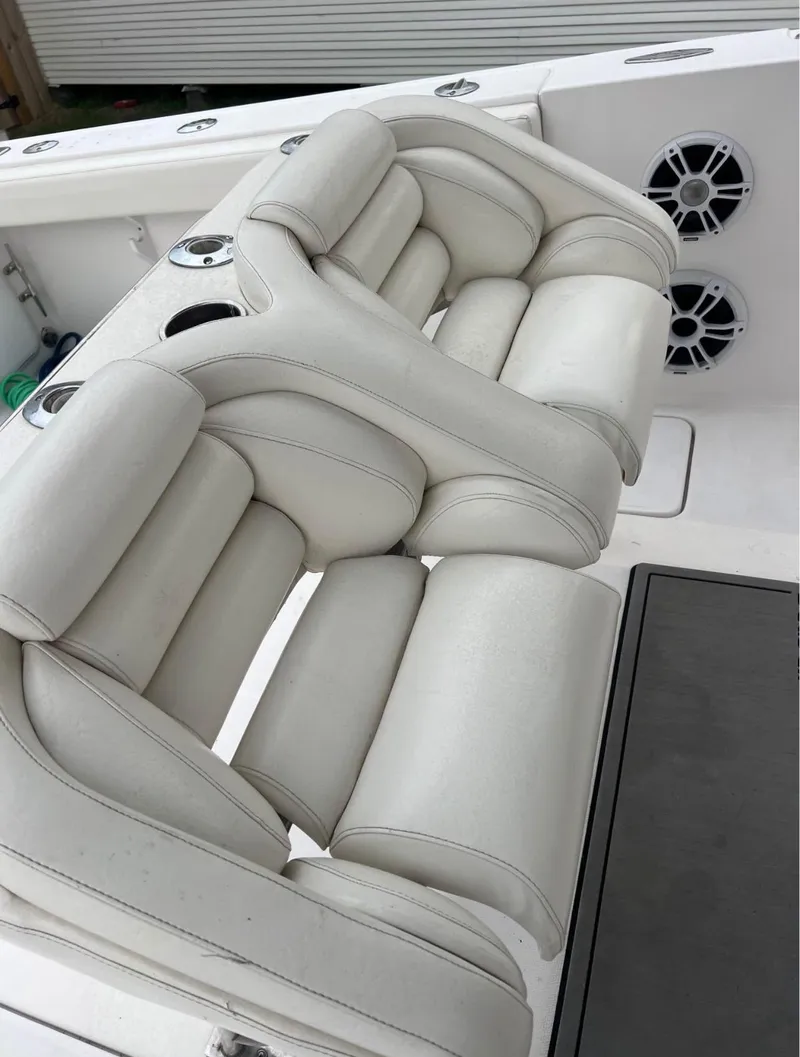 Slide: The Image of 2001 Donzi 32 ZF Open boat with white cushioned seating and built-in speakers. - 28