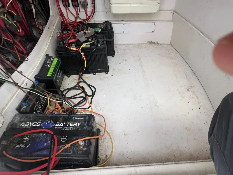 Slide: The Image of Battery compartment of a 2001 Donzi 32 ZF Open boat with wiring and batteries. - 29