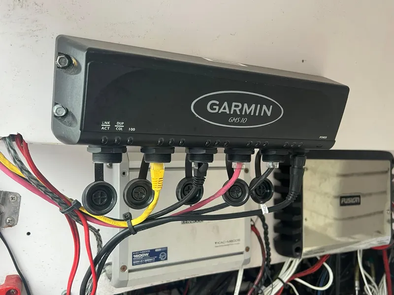 Slide: The Image of Garmin GMS 10 marine network hub with connected cables on a 2001 Donzi 32 ZF Open boat. - 31