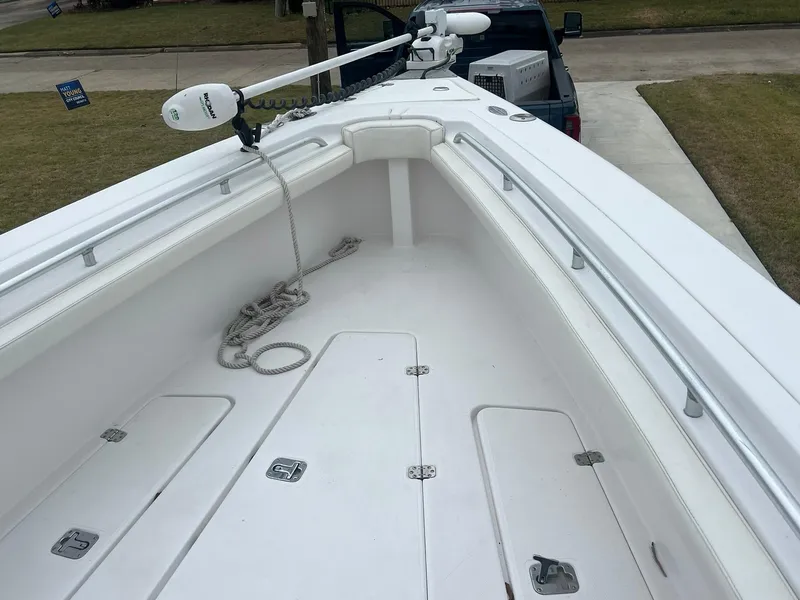 Slide: The Image of 2001 Donzi 32 ZF Open boat deck with storage compartments and trolling motor. - 33
