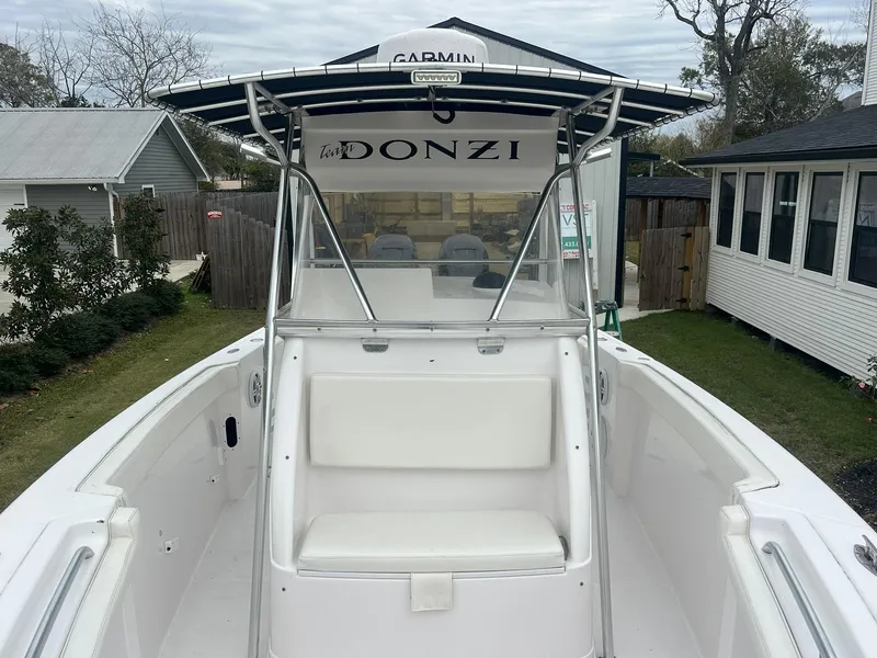 Slide: The Image of 2001 Donzi 32 ZF Open boat with white seating and Garmin equipment, docked outdoors. - 35