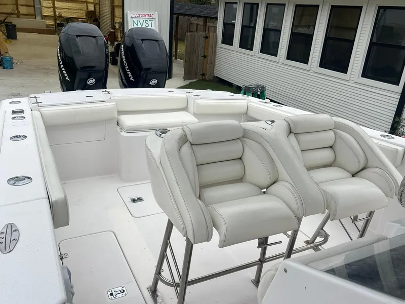 Slide: The Image of 2001 Donzi 32 ZF Open boat interior with white seating and dual outboard engines. - 39
