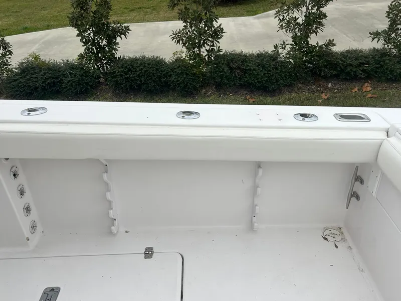 Slide: The Image of 2001 Donzi 32 ZF Open boat interior with white seating and rod holders. - 45