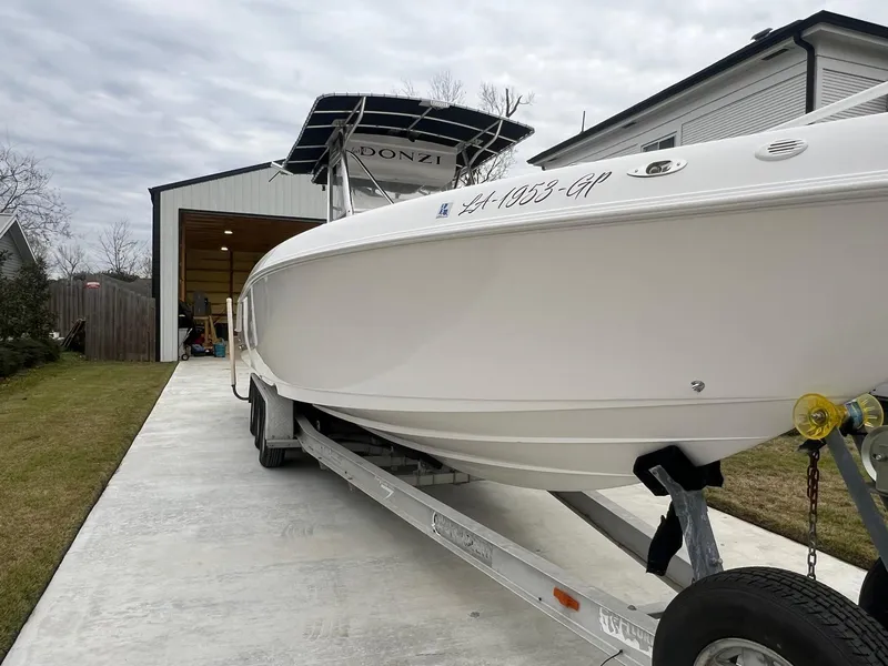 Slide: The Image of 2001 Donzi 32 ZF Open boat on trailer in driveway near garage. - 5