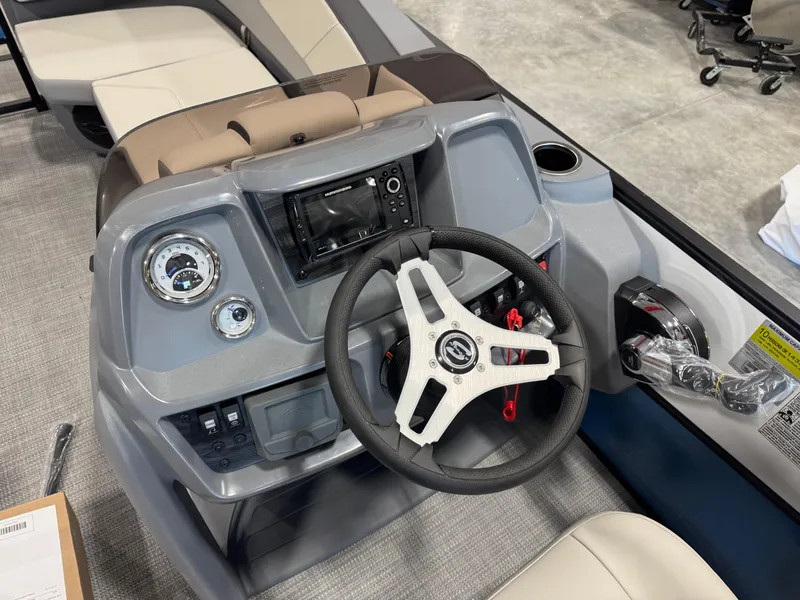 Slide: The Image of 2025 Sylvan A-22 Sport boat dashboard with steering wheel and control panel. - 13