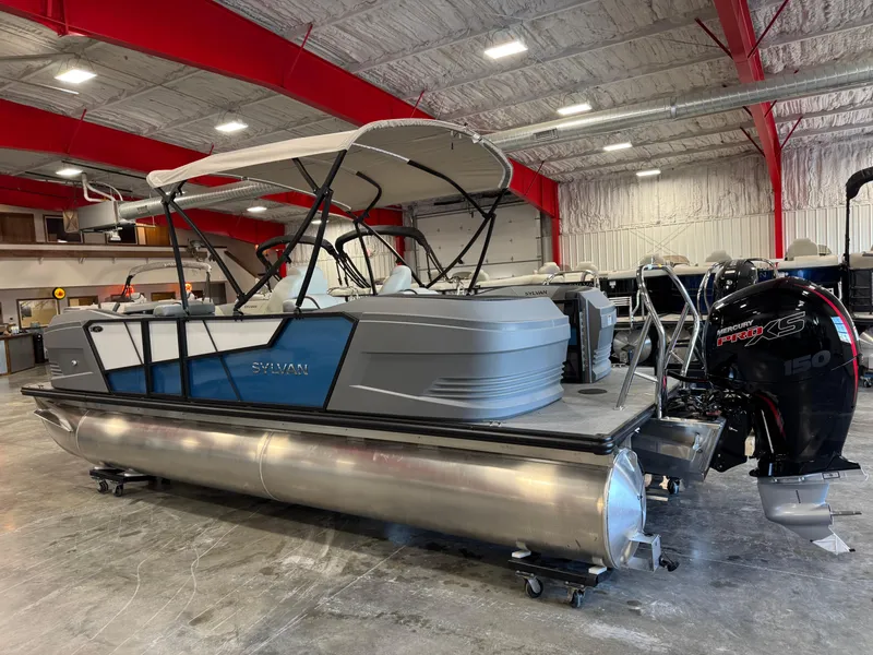 Slide: The Image of 2025 Sylvan A-22 Sport pontoon boat in a showroom with Mercury 150 outboard motor. - 3