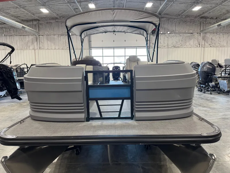 Slide: The Image of 2025 Sylvan A-22 Sport pontoon boat in a showroom, rear view. - 6