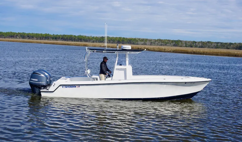 Slide: The Image of 1998 Contender 25 Open boat on calm water, featuring a Yamaha outboard motor. - 2