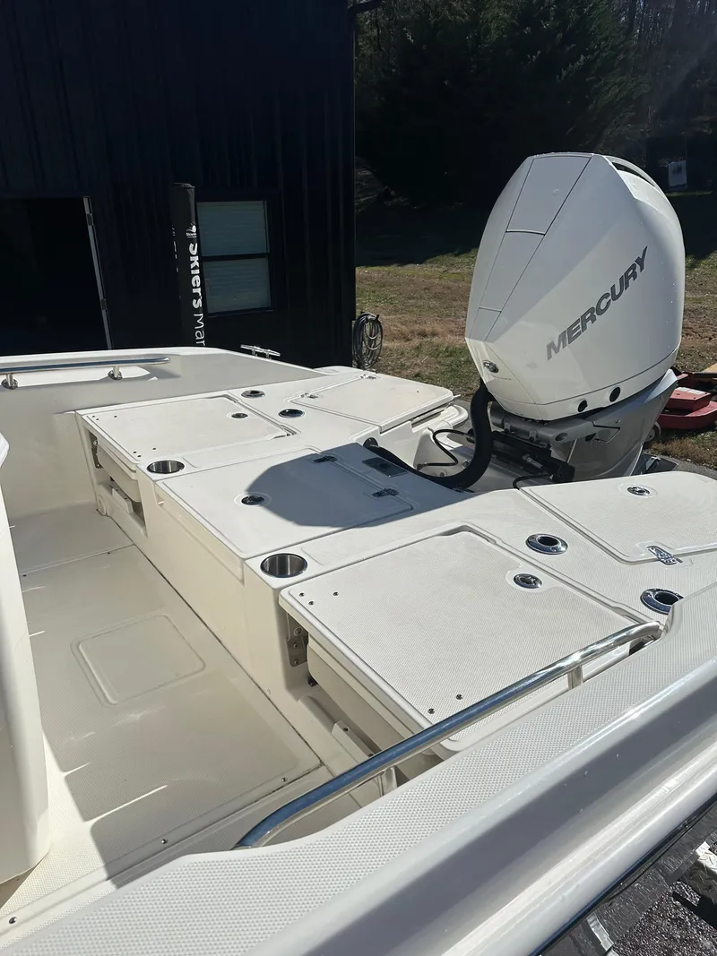 Slide: The Image of 2023 Boston Whaler 250 Dauntless boat with Mercury engine, outdoor setting. - 10