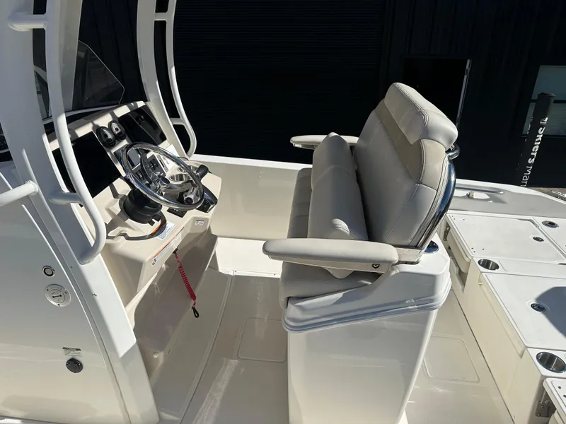 Slide: The Image of 2023 Boston Whaler 250 Dauntless boat interior with helm and seating area. - 12
