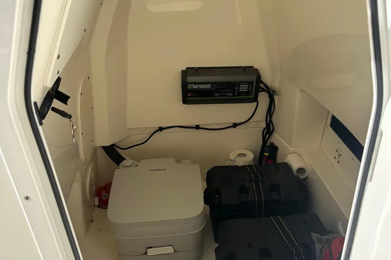 Slide: The Image of Interior of 2023 Boston Whaler 250 Dauntless boat, featuring storage and equipment. - 15