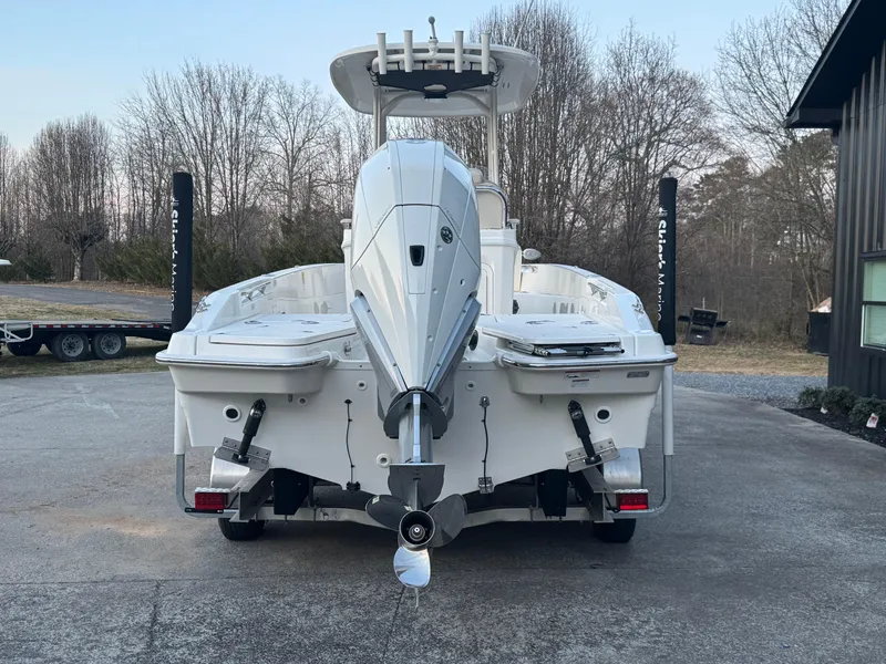 Slide: The Image of 2023 Boston Whaler 250 Dauntless boat, rear view, parked on a driveway. - 3