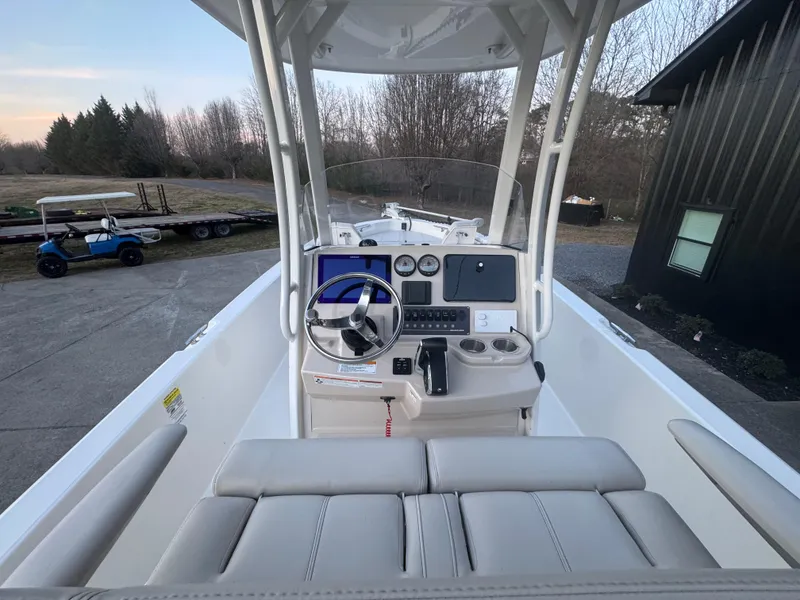 Slide: The Image of 2023 Boston Whaler 250 Dauntless boat interior with steering console and seating. - 4